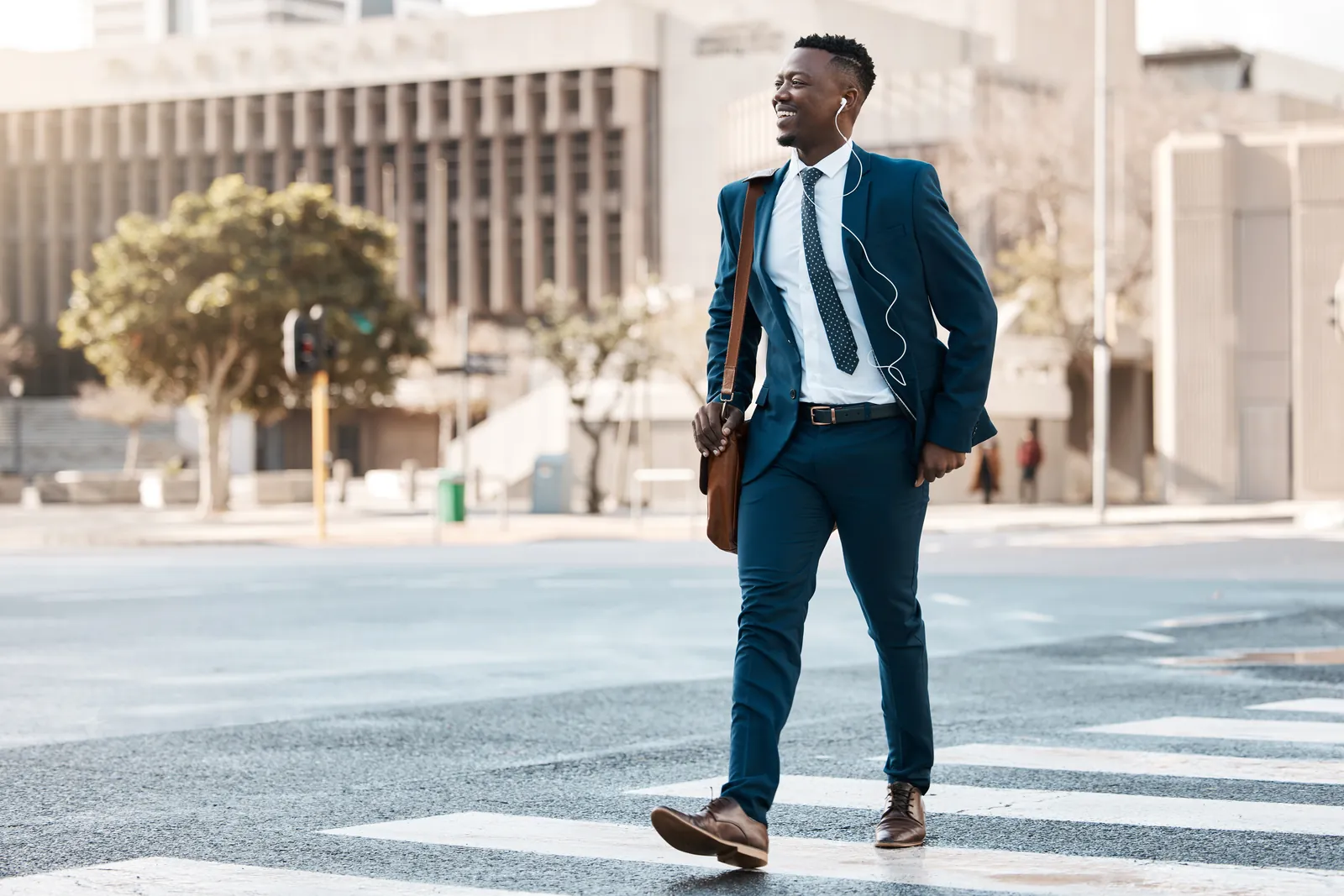 A confident man in a blue suit with earphones