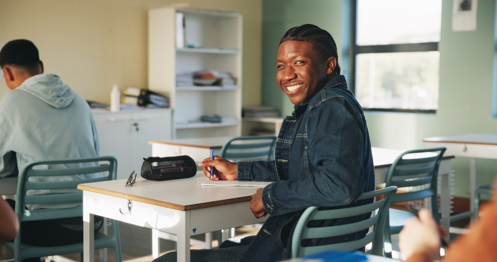 A student smiling in a classroom